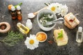 Composition with natural cosmetics and chamomile flowers on table