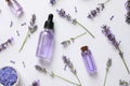 Composition with natural lavender cosmetic products and flowers on white background