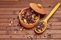 Composition of natural tea with a leaves of rose. Macro photo of tea petals in a wooden board. Tea with petals of Sudanese rose, b Royalty Free Stock Photo