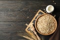 Composition oatmeal flakes and milk on wooden background