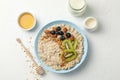 Composition oatmeal with fruits on white background