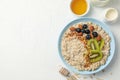 Composition oatmeal with fruits on white background