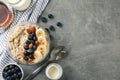 Composition oatmeal porridge with fruits on gray background