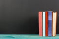 Composition with old vintage colorful hardback books, diary on wooden background Royalty Free Stock Photo