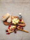 Composition with olive wood, olives, bread, cheese pieces in olive oil, spices Royalty Free Stock Photo