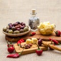 Composition with olive wood, olives, bread, cheese pieces in olive oil, spices Royalty Free Stock Photo