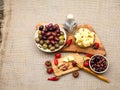 Composition with olive wood, olives, cheese pieces in olive oil, bread and spices Royalty Free Stock Photo