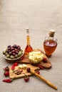 Composition with olive wood, olives, cheese pieces in olive oil, bread and spices Royalty Free Stock Photo