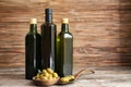 Composition with olives and oil in bottles on wooden background Royalty Free Stock Photo