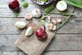 Composition with onions and garlic on wooden background Royalty Free Stock Photo