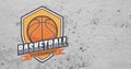 Composition of orange, white and black basketball tournament shield design, on concrete