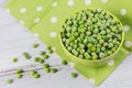 Composition with organic frozen vegetables on a white wooden background. Green peas in a bowl Royalty Free Stock Photo