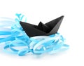 Composition with origami boat and paper ribbons on white background