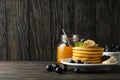 Composition pancakes, banana, blueberry and jam on wooden background