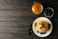 Composition with pancakes, banana blueberry and jam on wooden background, top view