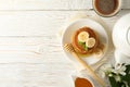 Composition pancakes on white wooden background, top view. Sweet breakfast