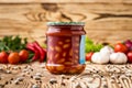 Composition of pickled beans with tomato in jar and ingredients Royalty Free Stock Photo