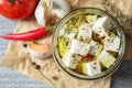 Composition with pickled feta cheese in jar on grey wooden table Royalty Free Stock Photo