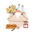 Composition of picnic basket with flowers and snacks for outdoor romantic dinner bottles of fruit lemonade, bread and