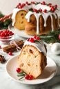 Composition with piece of traditional homemade Christmas cake on white marble table, closeup Royalty Free Stock Photo