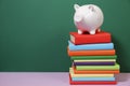Composition with piggy bank and hardback books Royalty Free Stock Photo