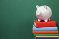 Composition with piggy bank and hardback books Royalty Free Stock Photo