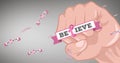 Composition of pink ribbon logo and believe text with fist