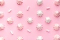 Composition of pink and white meringues on a pink paper background. Pastel