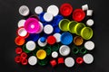 Composition of plastic bottle caps. Top view of recycled plastic bottle caps. Separate garbage collection. Recycling of plastic