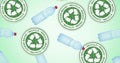 Composition of plastic bottles and recycling text and logo on green background Royalty Free Stock Photo