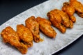 Plate of Buffalo chicken wings on a black background Royalty Free Stock Photo