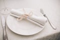 A composition of a plate, fork, knife and glass on the table, in the light colors of the restaurant Royalty Free Stock Photo