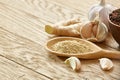 Composition of powder spices on spoon and different sorts of spicies on wooden table background, selective focus