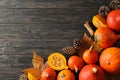 Composition With Pumpkins, Pine Cones And Leaves On Wooden Background