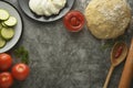 Composition with raw dought and fresh ingredients for pizza isolated on dark background. Copy space. Flat lay food ingredients Royalty Free Stock Photo