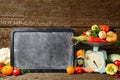 Composition of raw organic fresh vegetables, chalk board for texton, balance on wooden brown table
