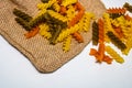 Composition of raw pasta uncooked tricolore fusilli, pasta twist shape. Close up and selective focus on colorful fusilli pasta Royalty Free Stock Photo