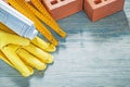 Composition of red bricks protective gloves blueprints wooden me Royalty Free Stock Photo