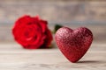 Composition with red heart and rose flower on vintage wooden table. Valentines day background. Copy space for text. Royalty Free Stock Photo