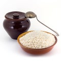 The composition of Rice groats in a clay pial next to a clay pot and a copper spoon, Royalty Free Stock Photo