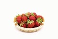 Composition of ripe strawberries on a white background in a wicker basket