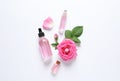 Composition with rose essential oil and flowers, top view Royalty Free Stock Photo