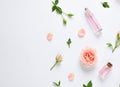Composition with rose essential oil and flowers on white background Royalty Free Stock Photo