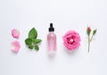 Composition with rose essential oil and flowers on white background Royalty Free Stock Photo