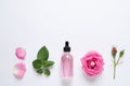 Composition with rose essential oil and flowers on white background Royalty Free Stock Photo