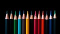 Row of colored pencils on black background Royalty Free Stock Photo