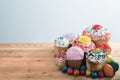 Composition Russian Easter cakes in glaze and decorations on a wooden table with colored eggs