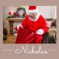 Composition of saint nicholas day text over santa claus holding red sack with presents Royalty Free Stock Photo