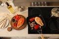 Composition with salmon steaks and vegetables in frying pan, above view Royalty Free Stock Photo