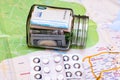 Composition with saving money banknotes in a glass jar with pills on map. Concept of investing and keeping money for healthcare Royalty Free Stock Photo